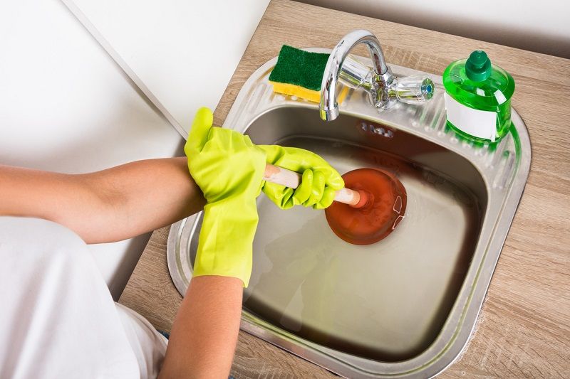 unclogging drain in kitchen sink