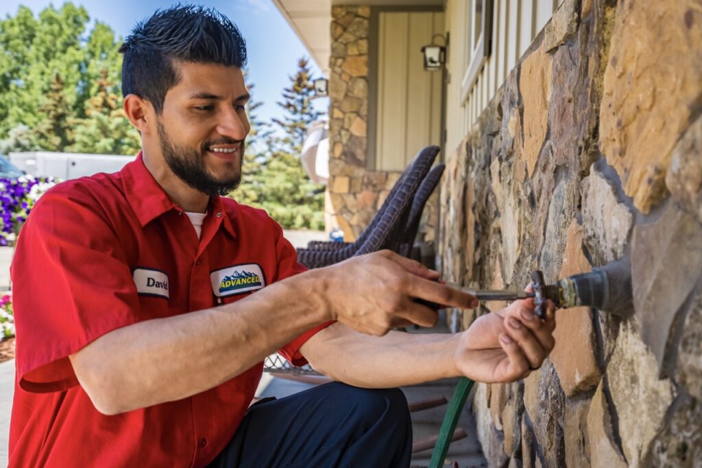 Technician preforming sprinkler repairs.